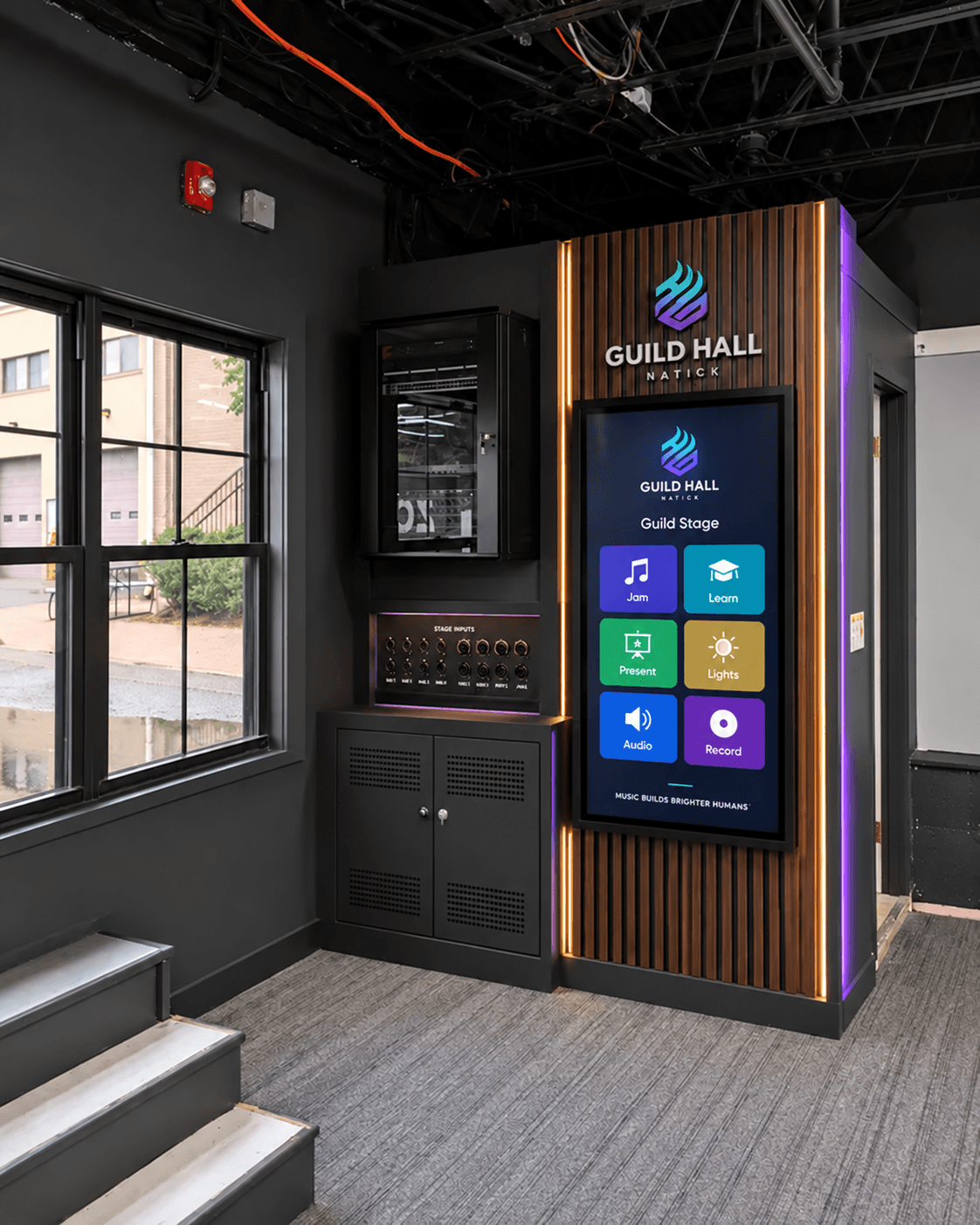 Guild Stage controls showing a touch display, microphone and instrument inputs, and AV cabinet